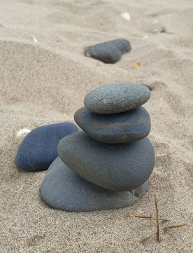 Stones stacked on sand